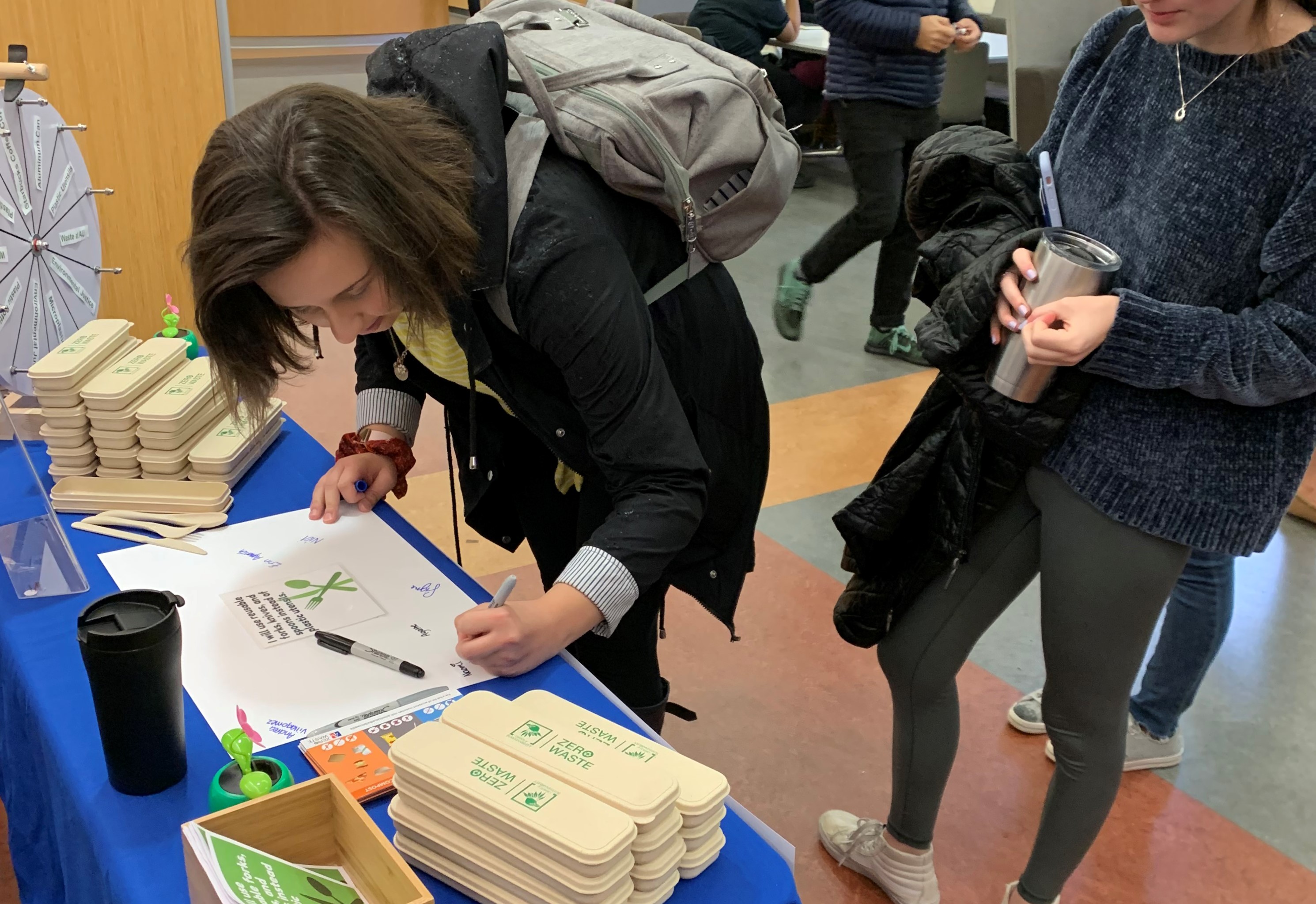Student signing waste reduction pledge