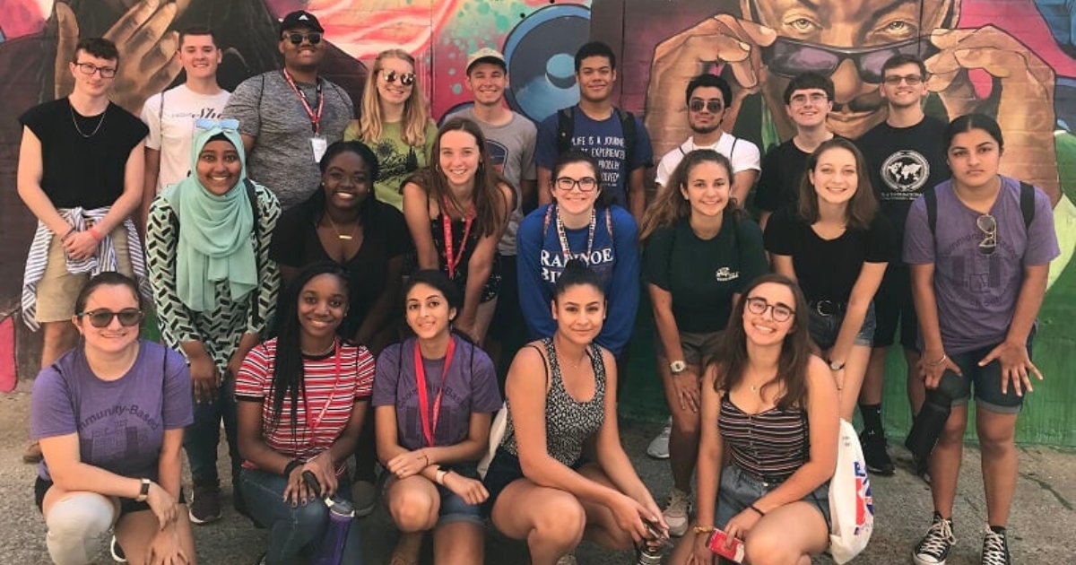 Group of AU Honors students in front of mural