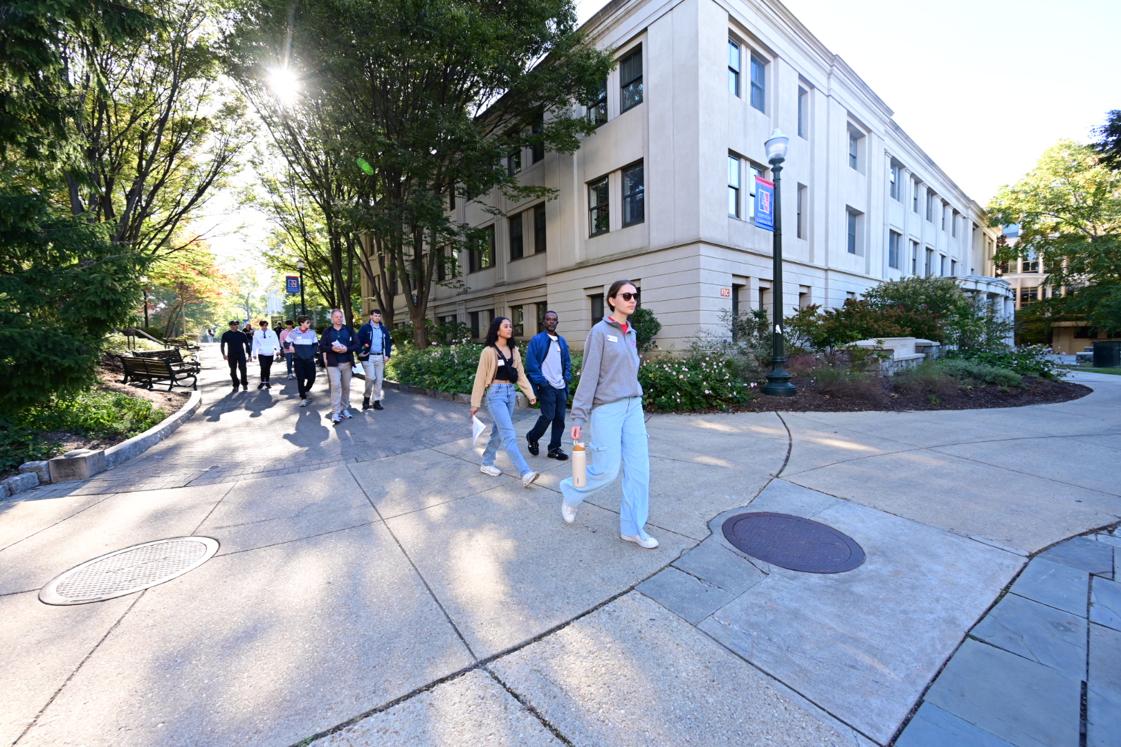 An AU Ambassador tour guide leading prospective families on a tour of the AU campus.