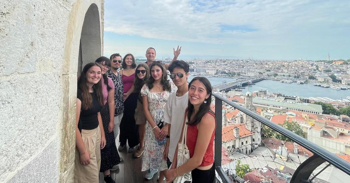 Tour group at the top of Galata Tower with Istanbul in the background