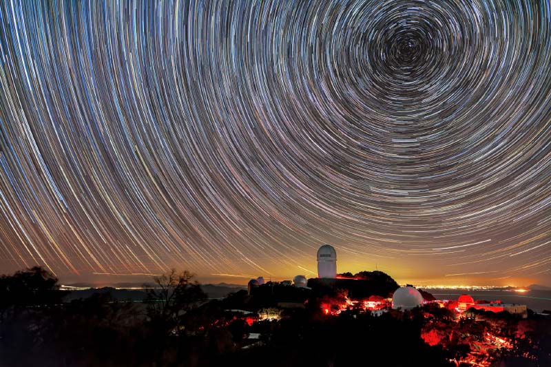 Mayall Telescope, shown beneath star trails captured in a long-exposure image. 