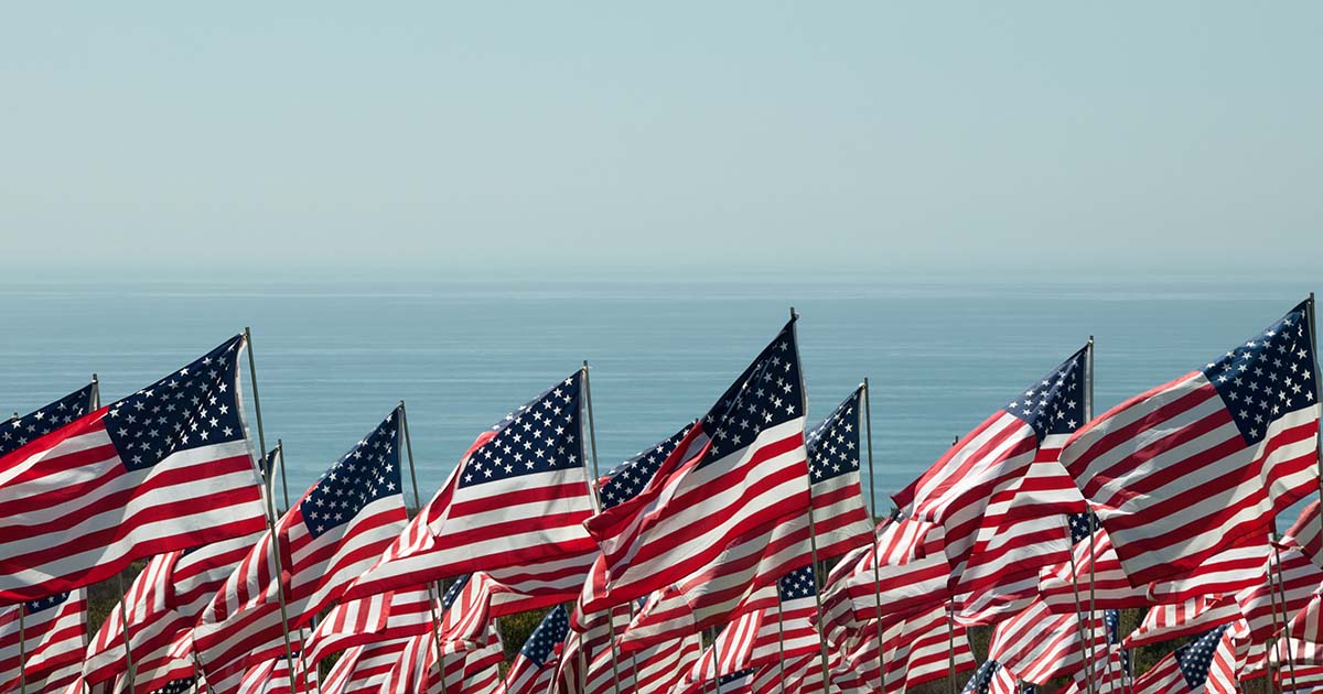 American flags flown near the ocean