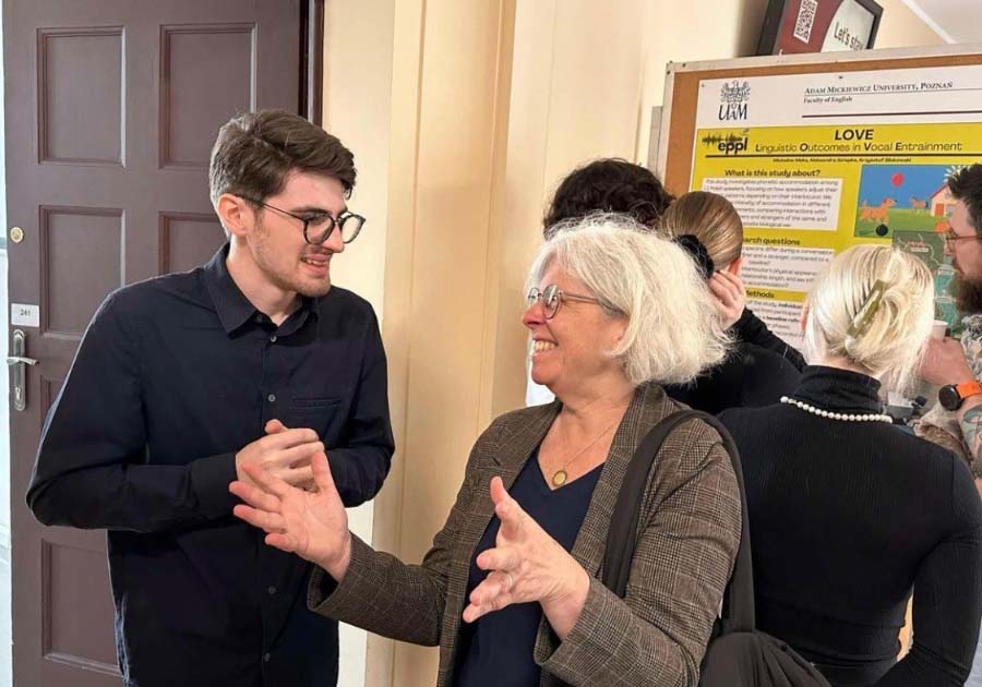 Mary Ellen Curtin gestures during conversation with a Polish student