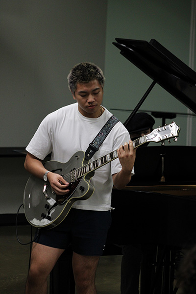 Student plays electric guitar