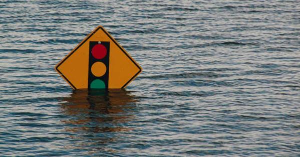 Traffic light sign partially underwater during flood