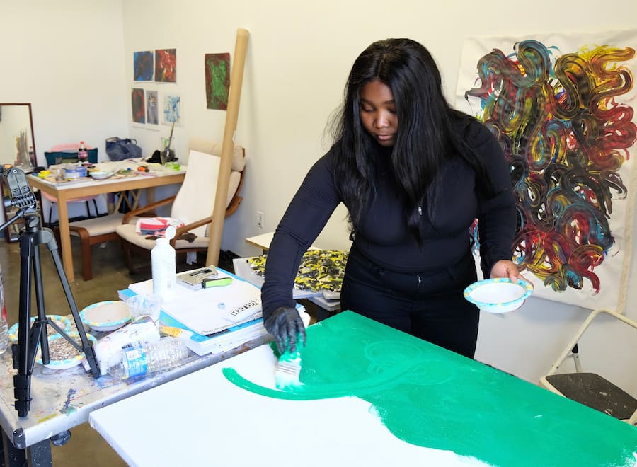 MFA student at work on a painting.