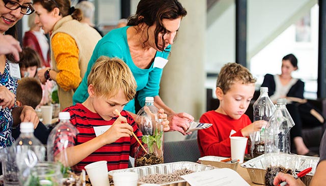 Children in an art workshop with teachers and parents