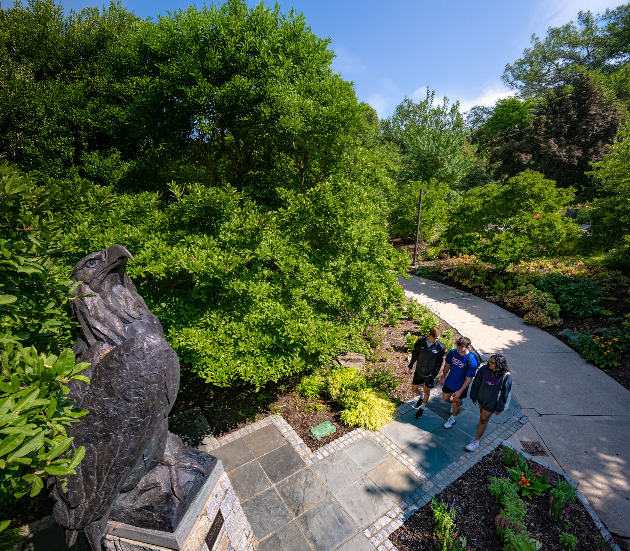 Students walk beneath the eagle statue.