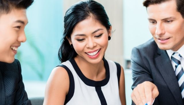 Three professionals collaborating on a document