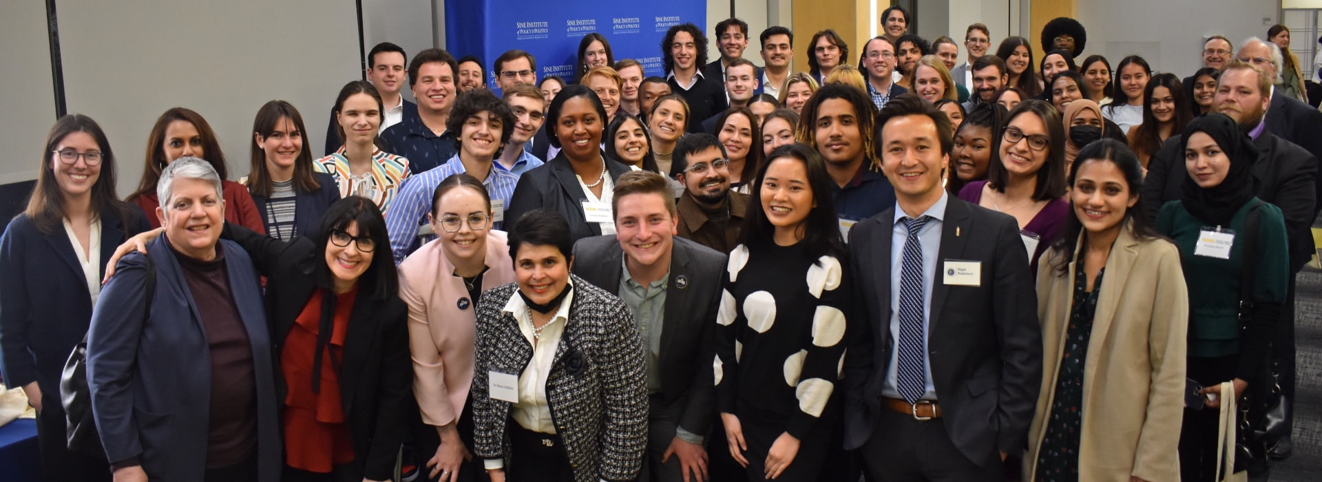 A group of people from the Sine Institute's Uncommon Table Dinner event pose for the camera