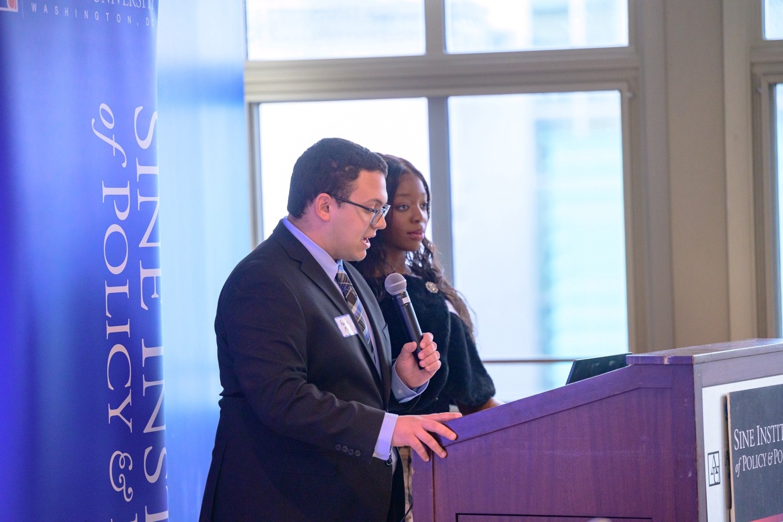 Sine students at podium