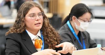SIS student Coralie Arias works with other students at the global youth forum