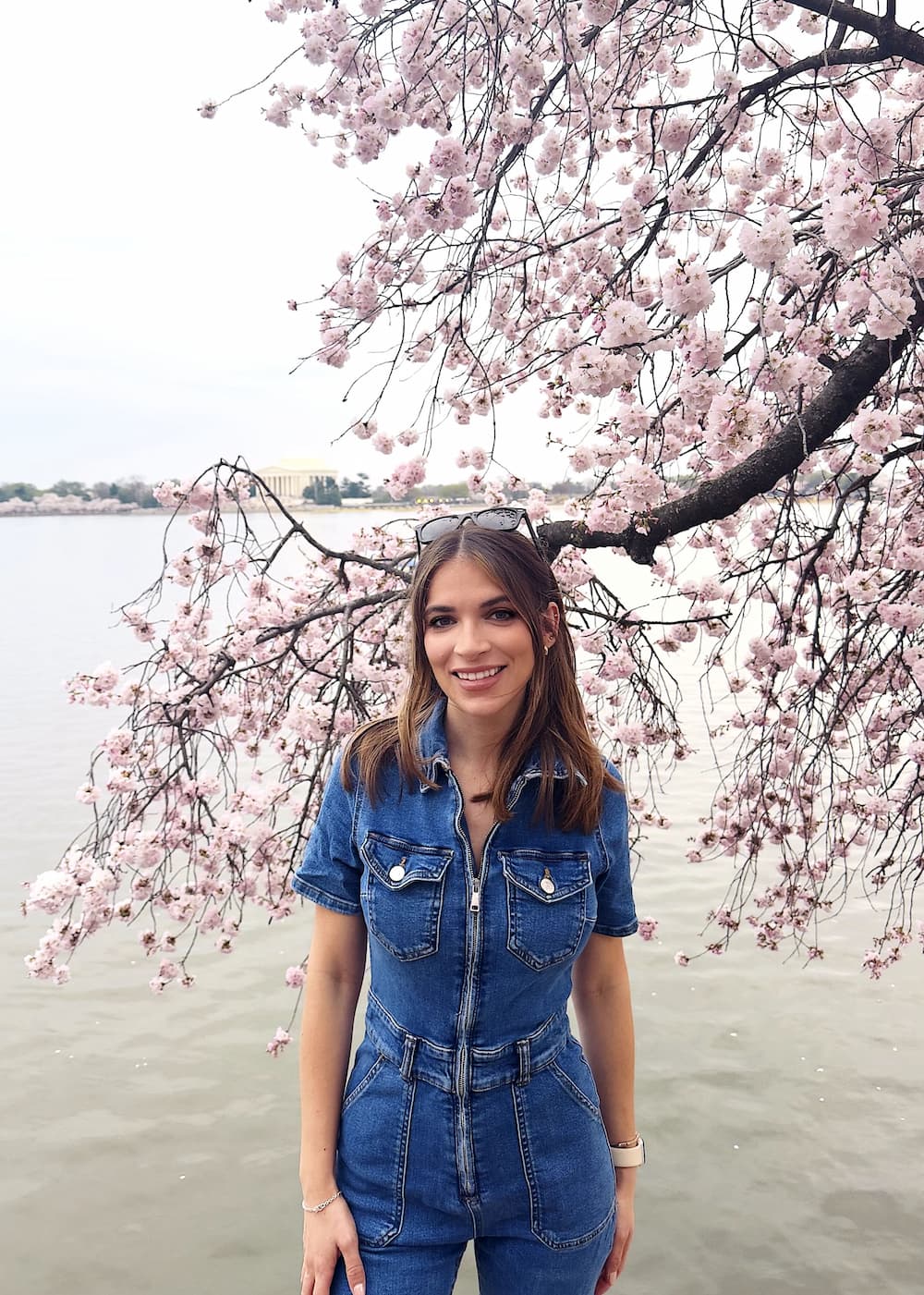 Julia Riera in front of cherry blossoms