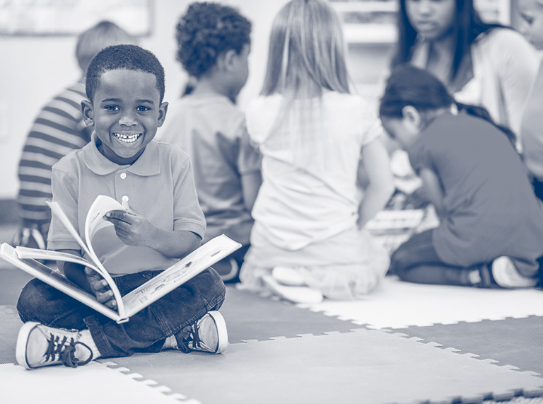 A boy flips through a picture book
