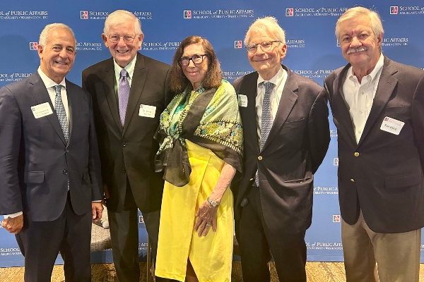 five speakers standing in front of an AU SPA banner