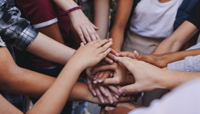 children putting hands together