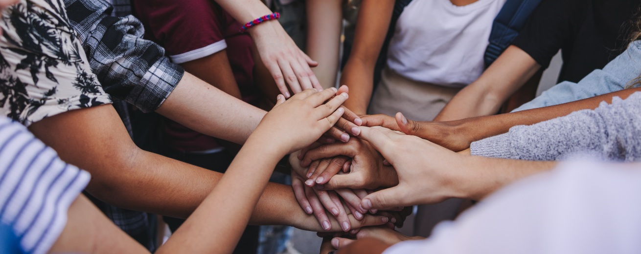 group of people putting hands together