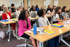 mixed race women sitting in a classroom