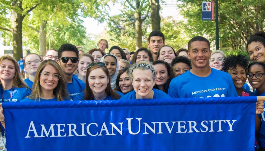 Orientation leaders holding an American University banner