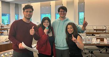 From left to right: Kyle Patlove, Verity Benzion-Dunams and Zach Buckler with Adjunct Professor Erin Auerbach